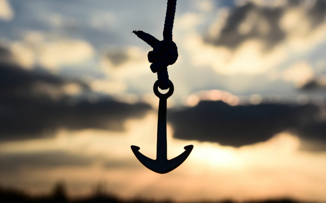 An anchor silhouetted in an ominous sky represents the weight of burnout.